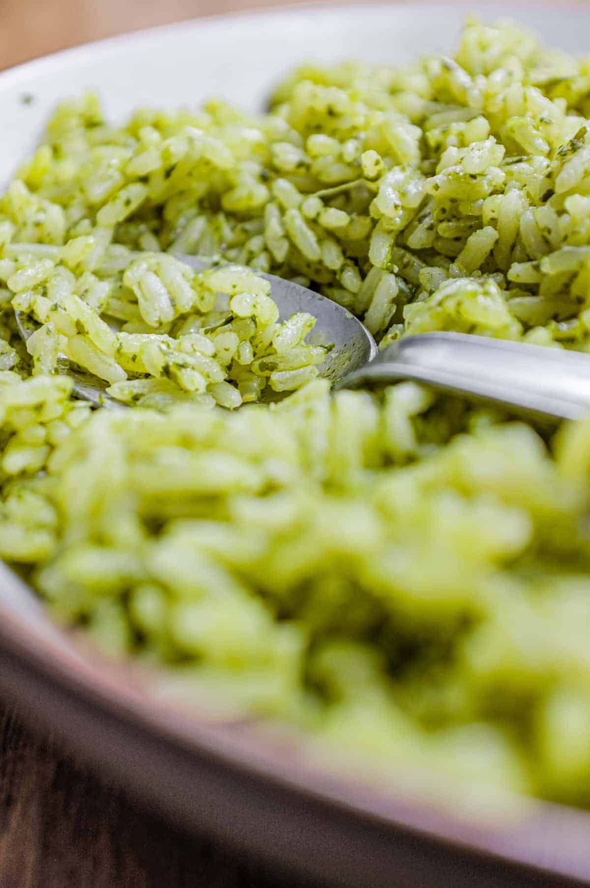 A bowl of Mexican Cilantro Rice (Green Rice) with a spoon.