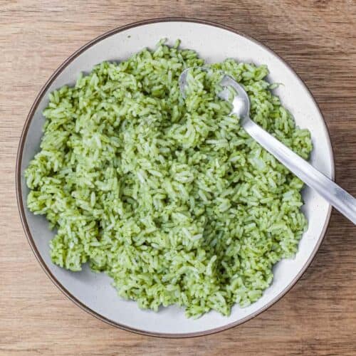 A bowl of Mexican Cilantro Rice (Green Rice) with a spoon.