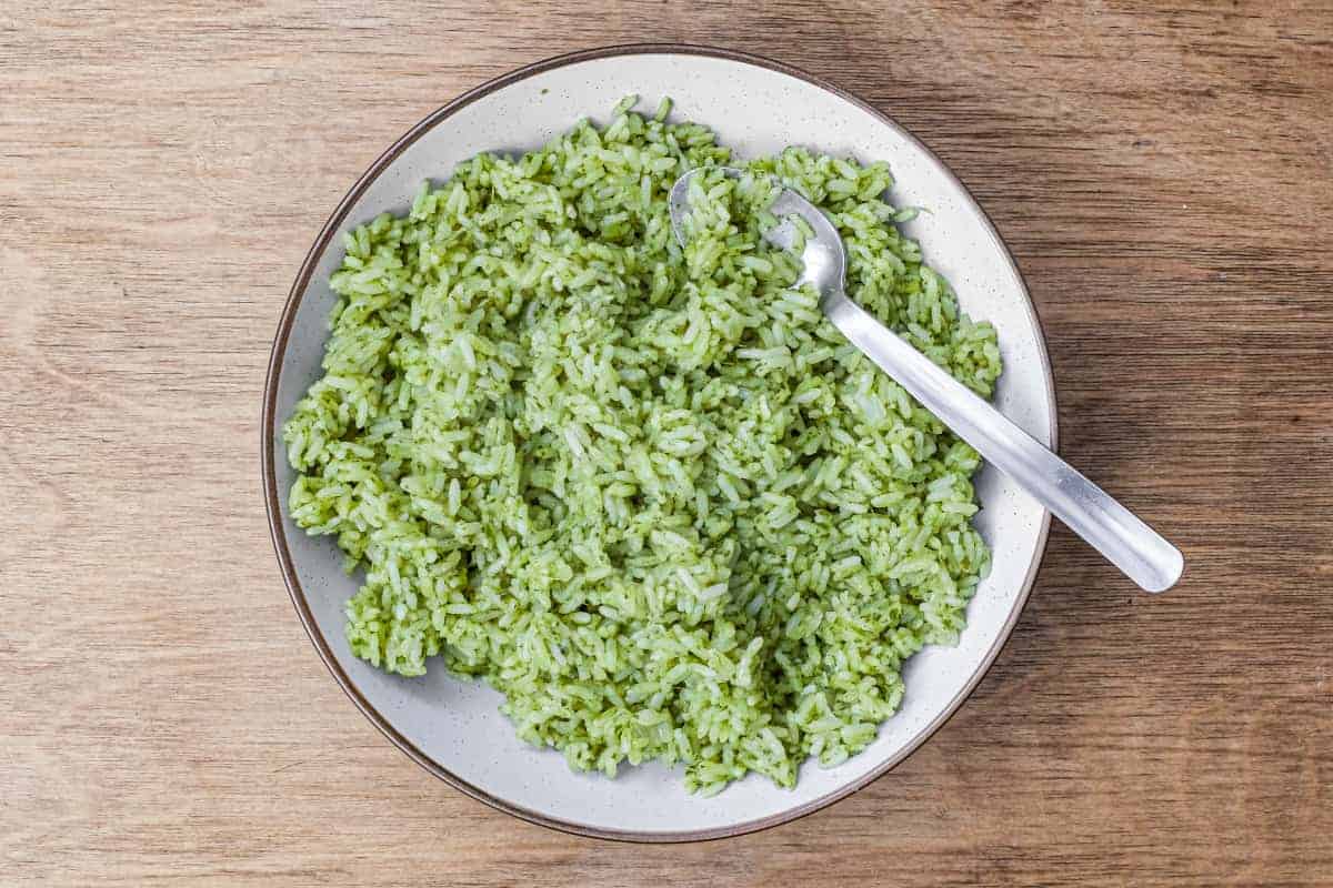 A bowl of Mexican Cilantro Rice (Green Rice) with a spoon.