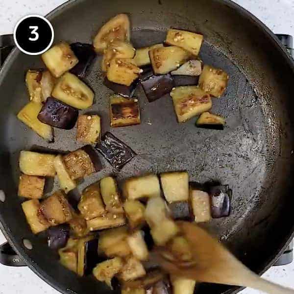 Frying cubes of eggplant in a small pan