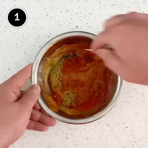 Blending a curry powder in a small bowl