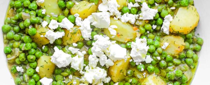 A bowl of Arakas Latheros (Greek Peas) garnished with feta cheese. 