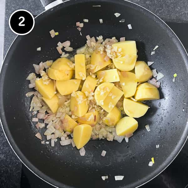 Potatoes and onions frying in a pan