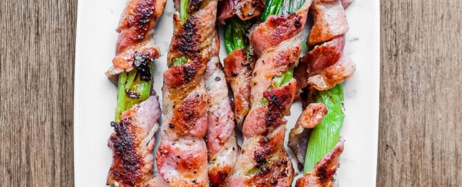 A platter of charred spring onions wrapped in pancetta