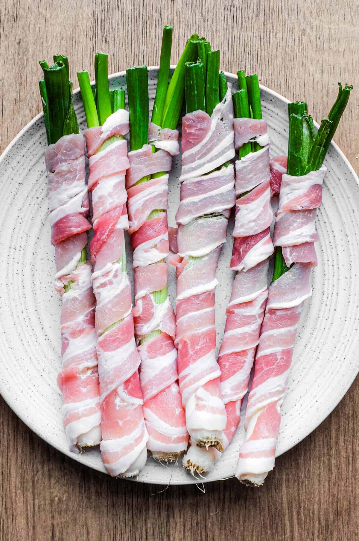 A platter of spring onions wrapped in pancetta