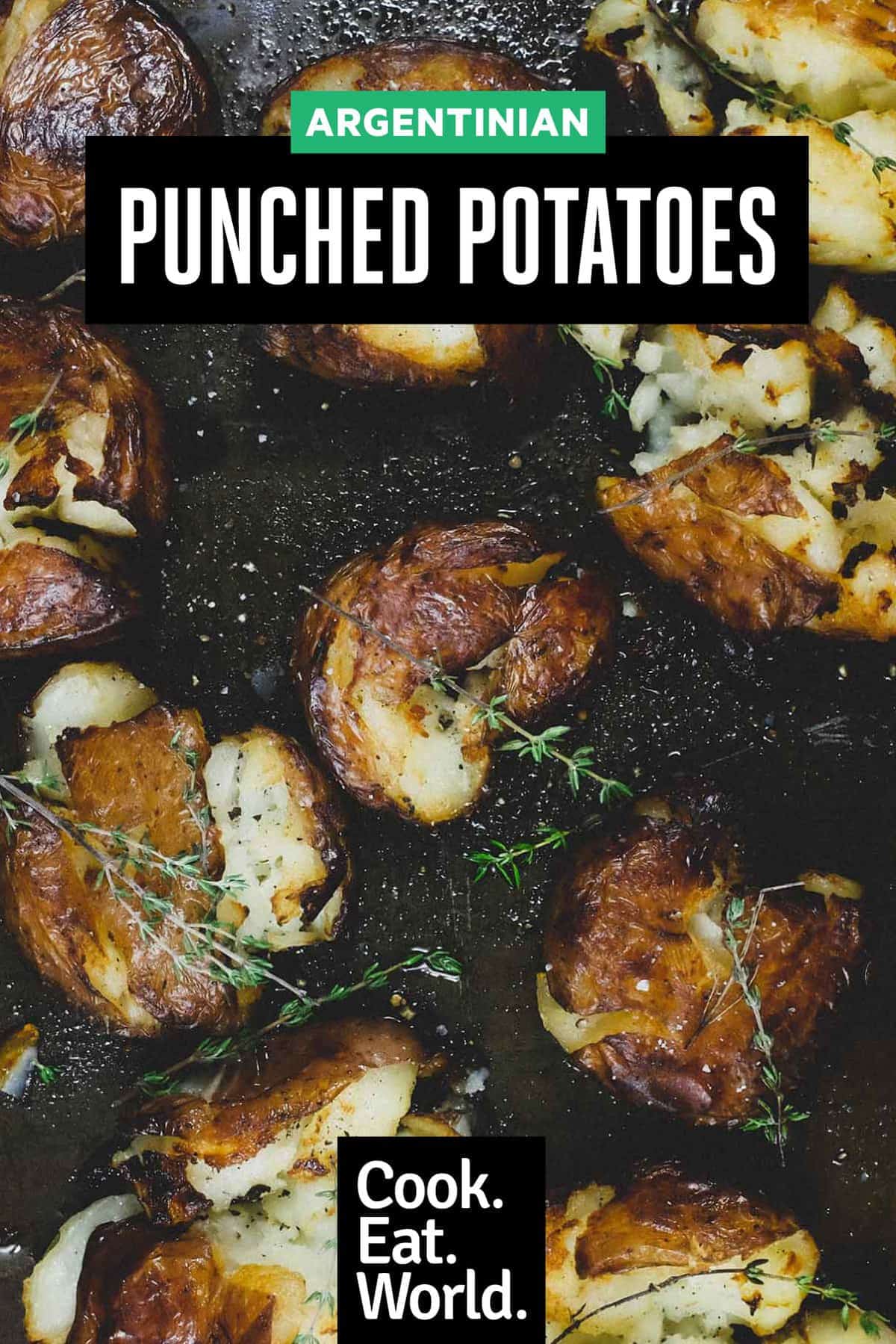 Punched potatoes on a baking sheet garnished with a little fresh thyme.