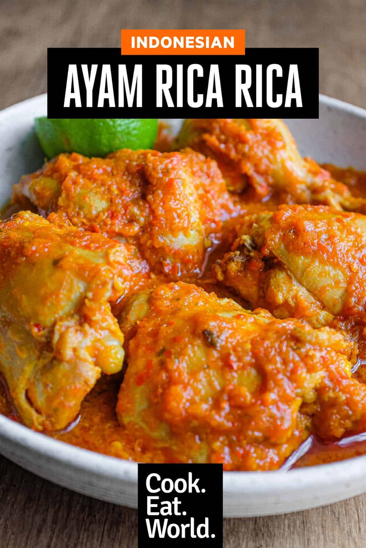 A bowl of Indonesian Ayam Rica Rica. A lime segment sits alongside as a garnish.