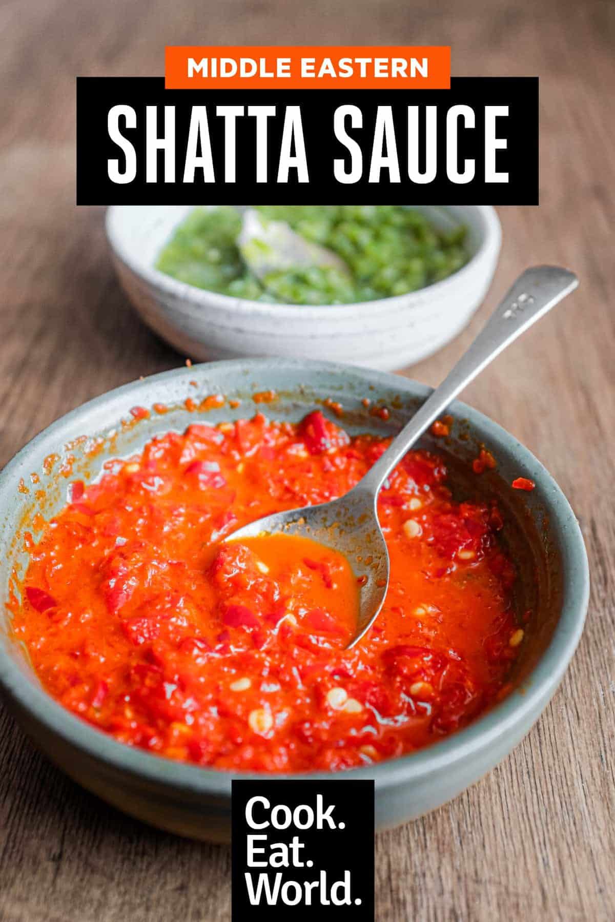 Two bowls of Middle Eastern Shatta Sauce. A red sauce sits in the foreground with a green sauce in the background.