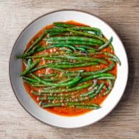 Green Beans (French Beans) cooked in a tangy red tomato sauce with Turkish Aleppo Pepper