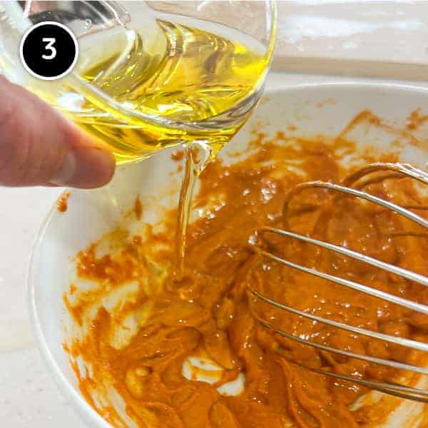 Making smoked paprika mayonnaise by pouring oil into the mayonnaise