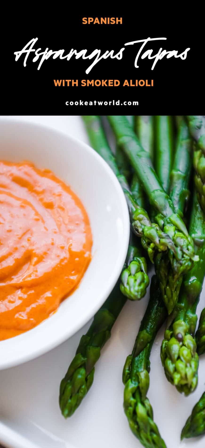 A small bowl of smoked alioli mayonnaise alongside some cooked asparagus