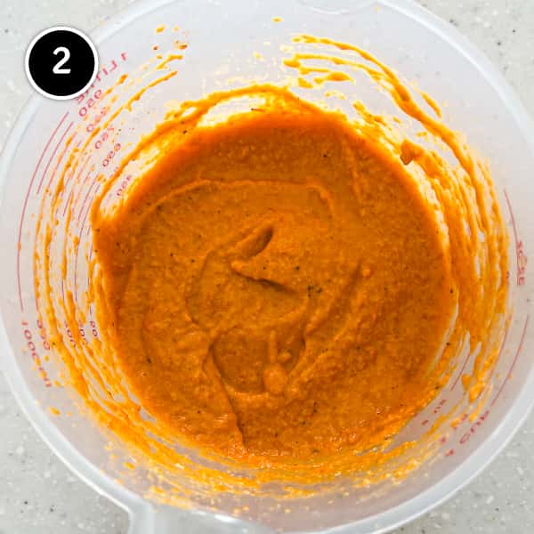 Freshly blended Spanish Romesco sauce in a plastic jug