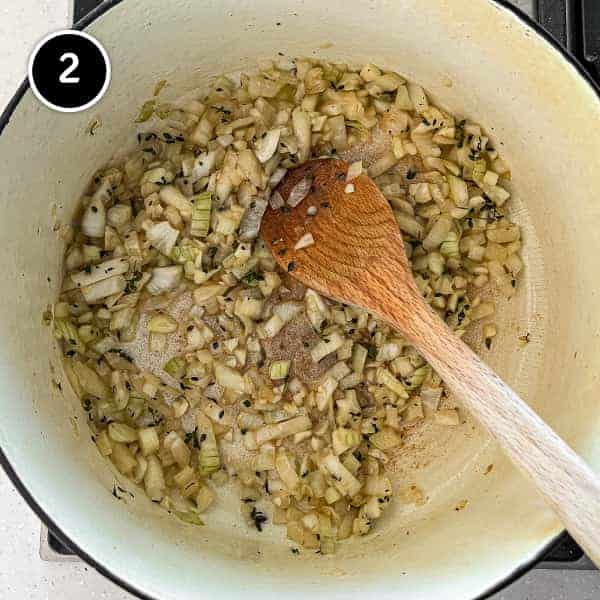 onion and garlic with thyme frying in a pan.