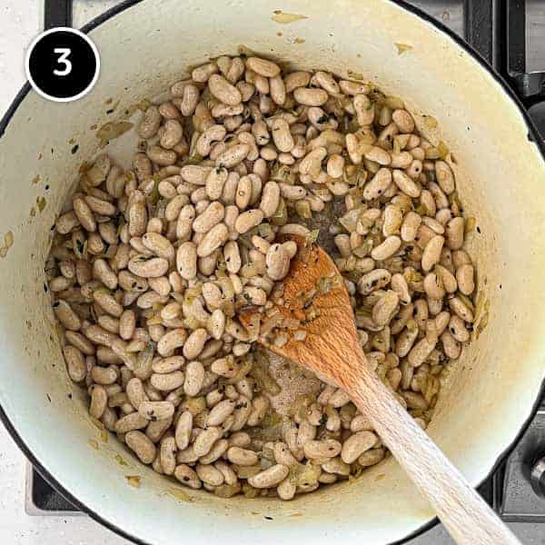 Beans being added to sauted onion and garlic and onion