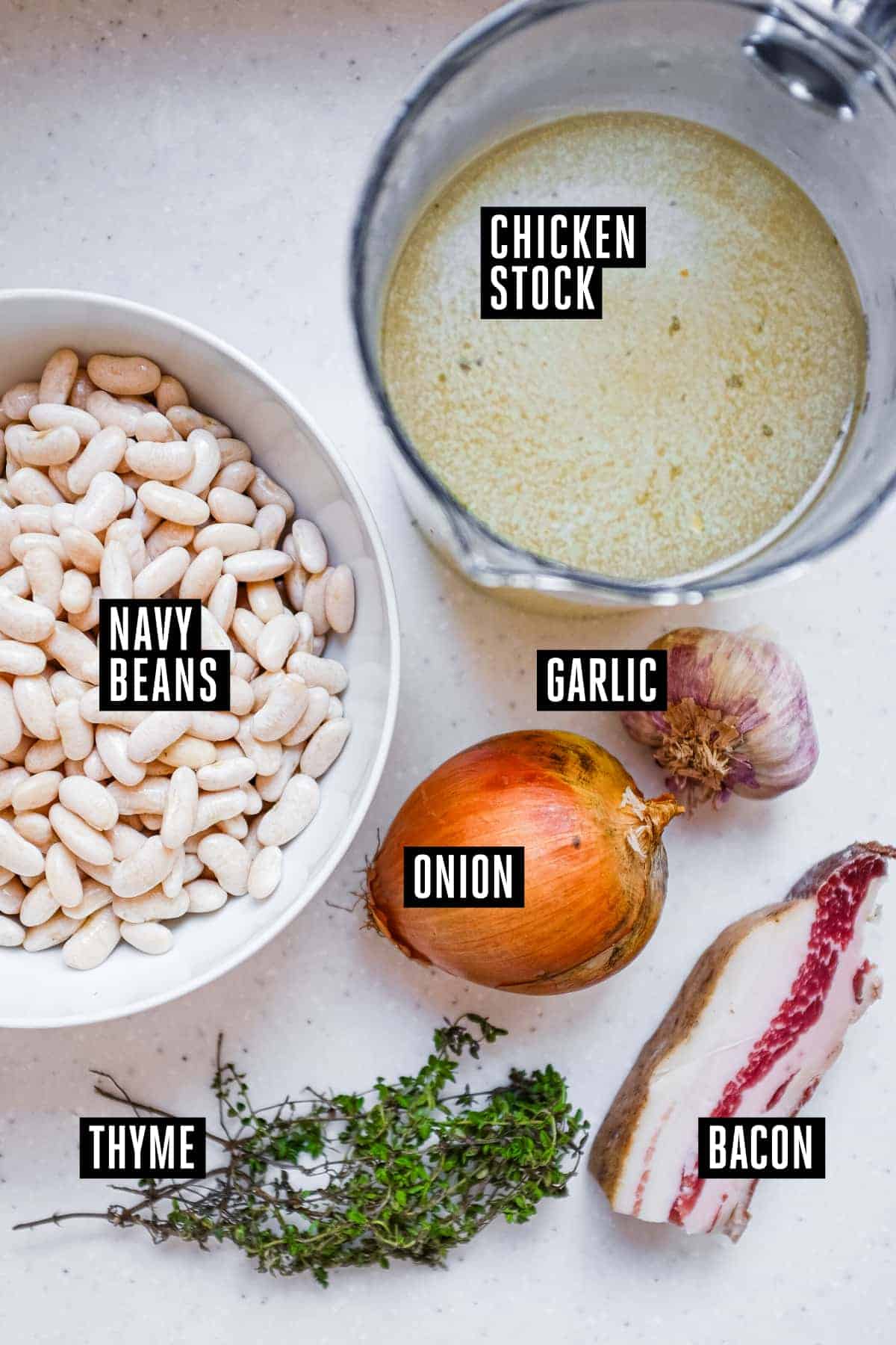 The labelled ingredients for a French garlic soup with beans and bacon