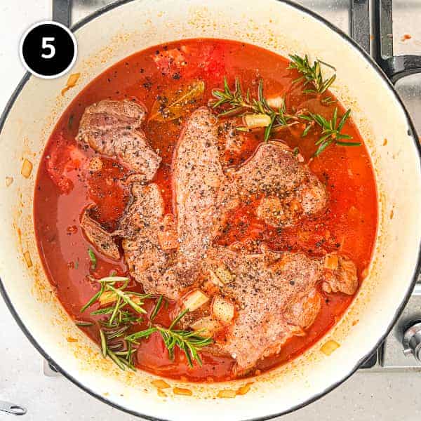 Lamb stewing in a pan with an nduja sauce