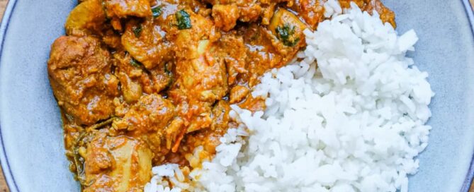 A bowl of chicken Peratal curry with rice
