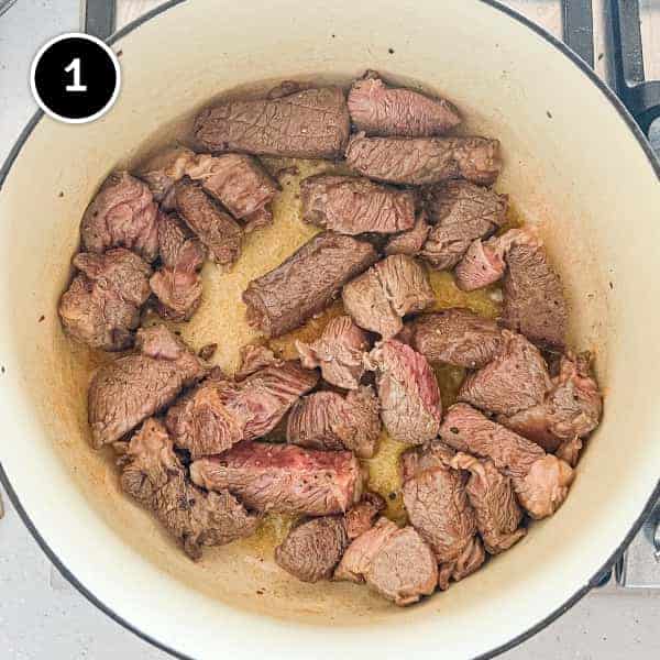 Beef pieces frying in a pan