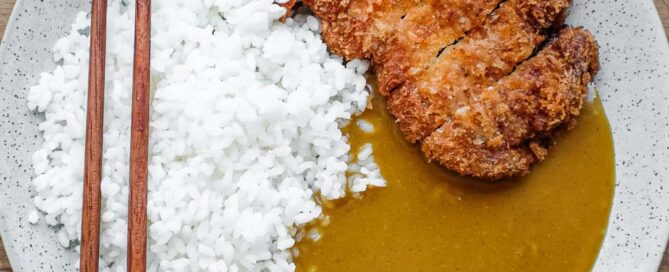 A plate of Japanese pork katsu curry with rice.