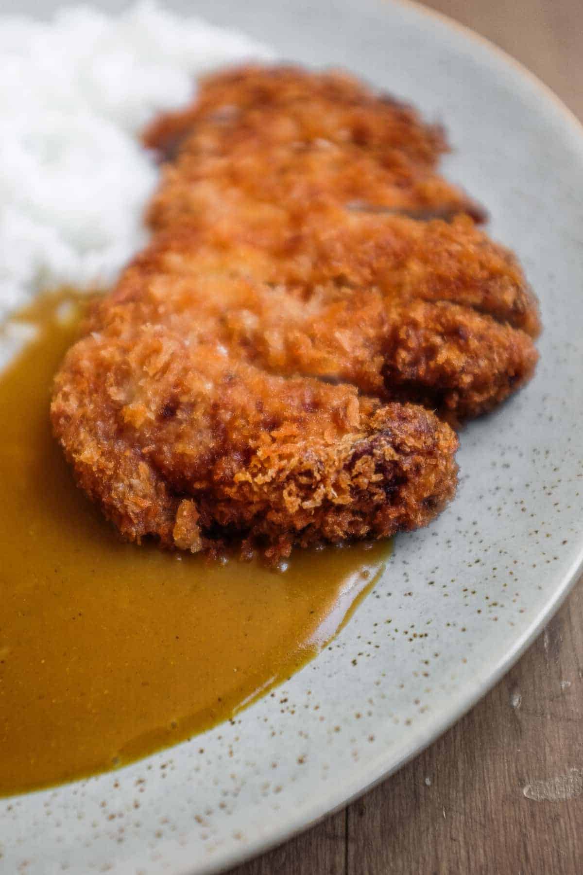 A plate of Japanese pork katsu curry with rice.
