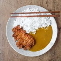 A plate of Japanese pork katsu curry with rice.