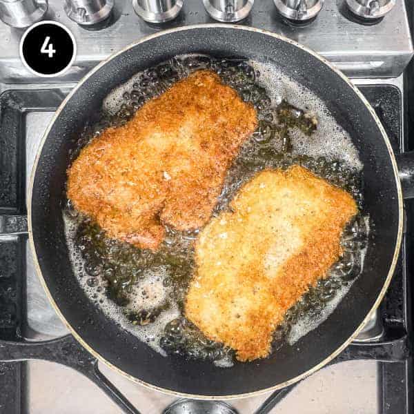 Pork katsu frying in a small pan