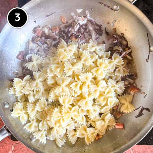 Pasta Al Radicchio & Pancetta | cookeatworld.com cooked farfalle pasta with radicchio and pancetta in a large pan.