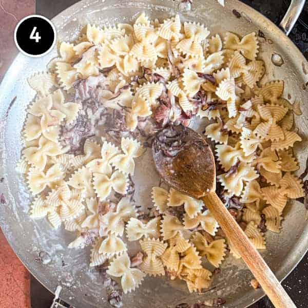 Pasta Al Radicchio & Pancetta | cookeatworld.com Farfalle pasta with radicchio and pancetta in a creamy sauce in a large frying pan.