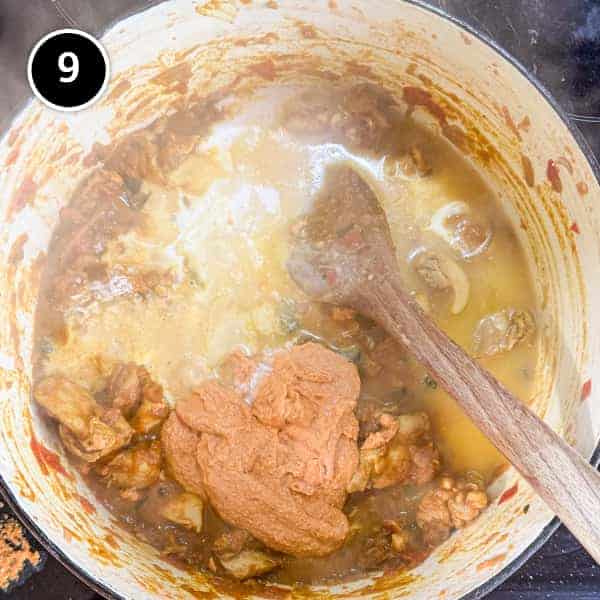 Andhra Chicken | cookeatworld.com Andhra chicken curry cooking in a large cast iron pot.