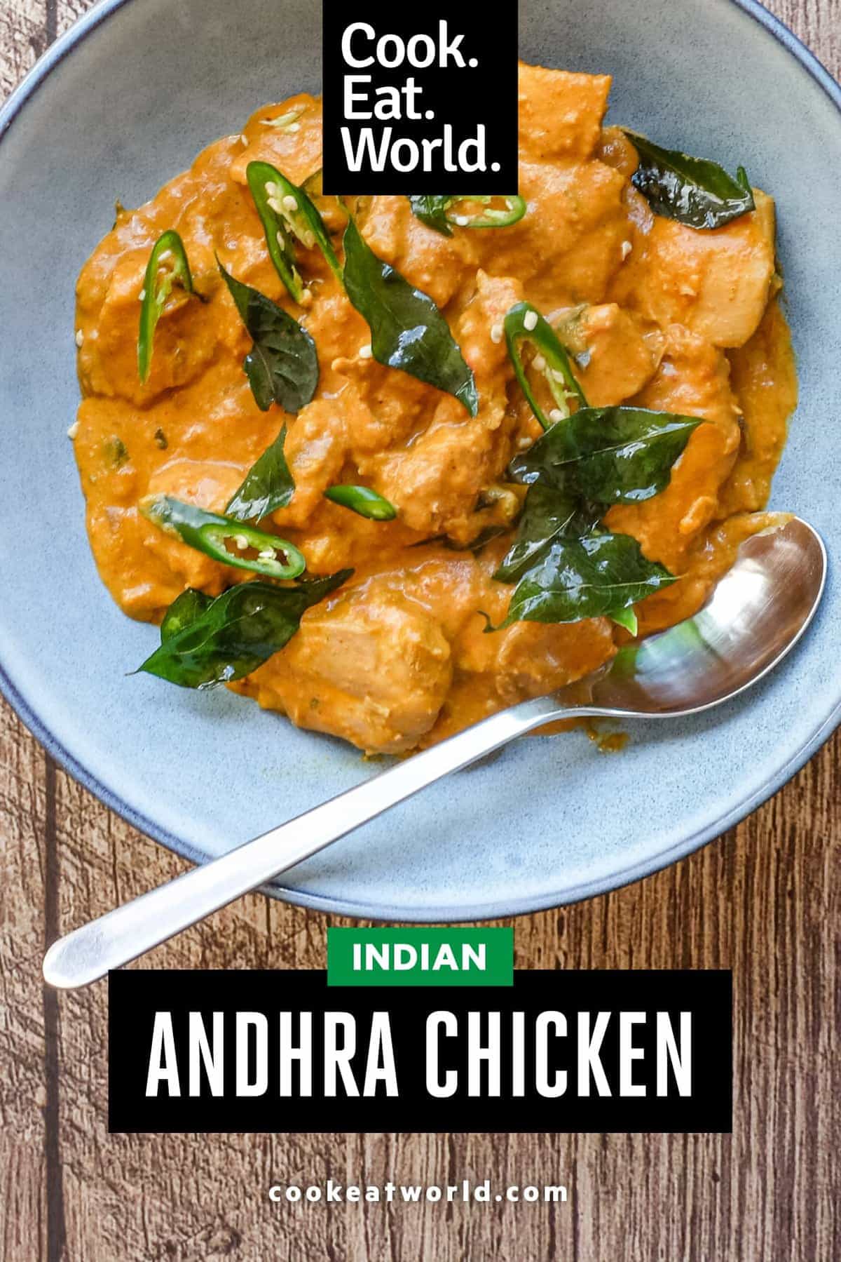 A bowl of Andhra chicken curry garnished with fried curry leaves
