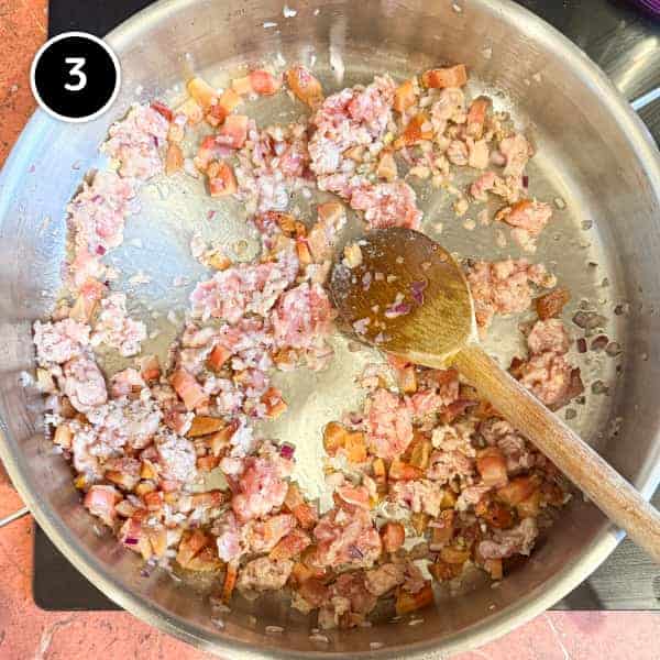 Pasta Alla Zozzona – cookeatworld.com A pan of guanciale, sausage and onion frying