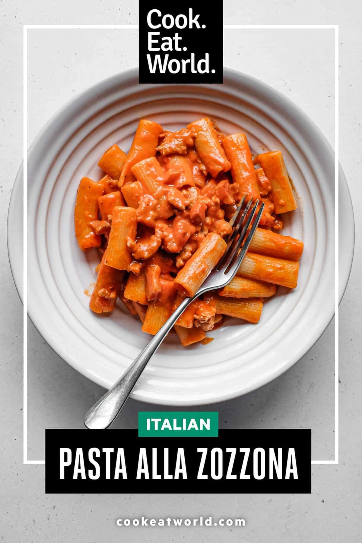A bowl of Pasta Alla Zozzona in a rich tomato sauce with a fork.