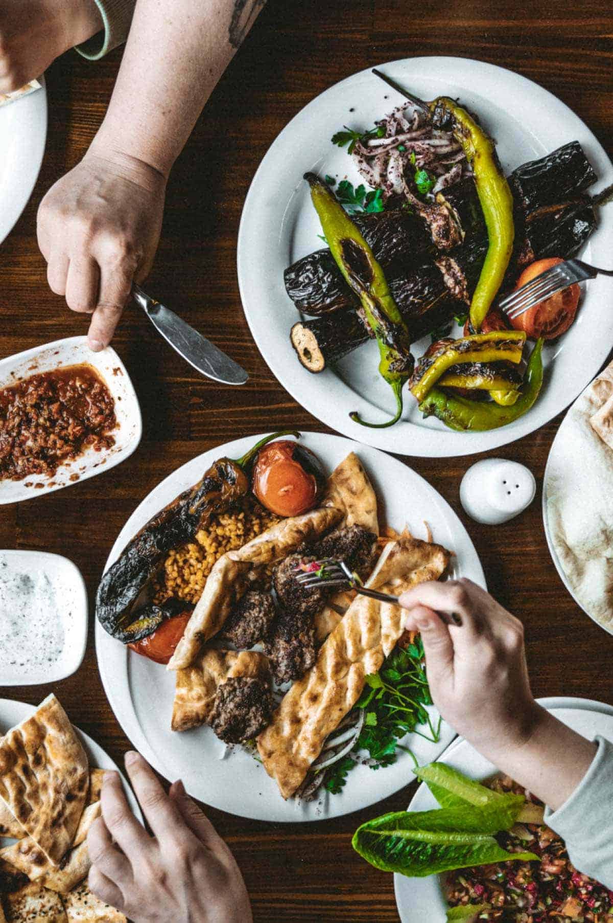 A colourful spread of Middle Eastern dishes including mezze, grilled meats, rice, salads and dips, representing authentic Middle Eastern cuisine.