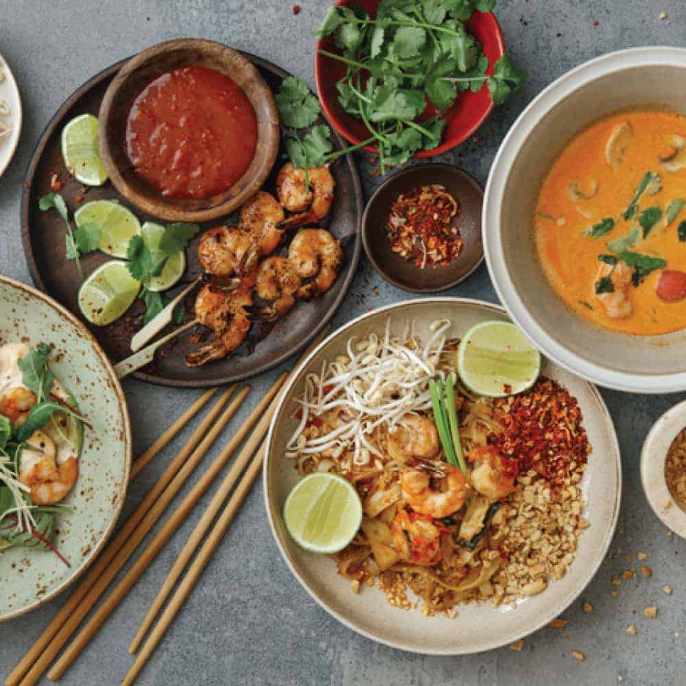 An array of Asian dishes on plates