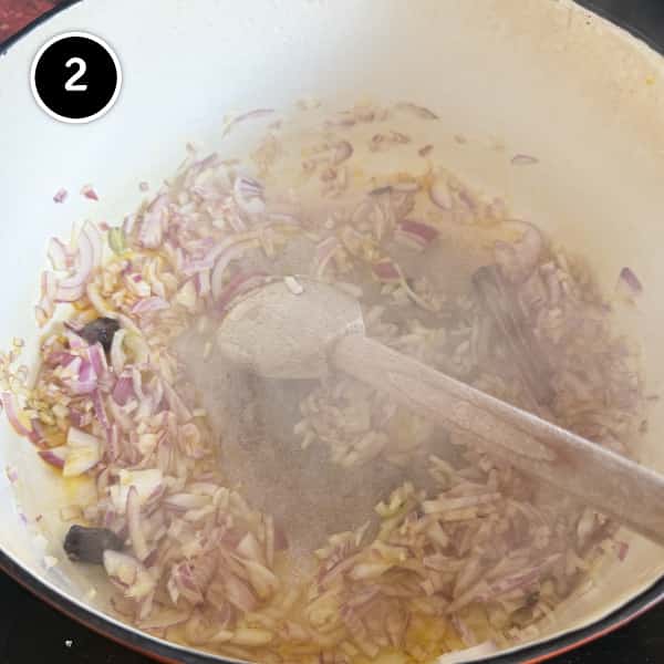 Chicken Rogan Josh | cookeatworld.com Frying onion in mustard oil.