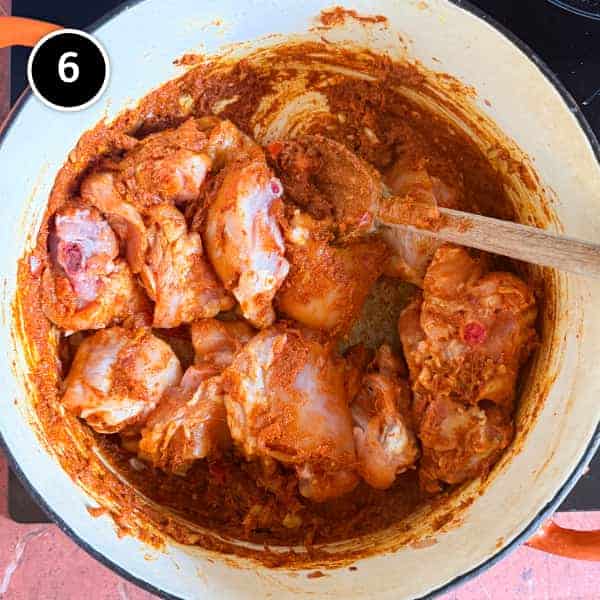 Chicken Rogan Josh | cookeatworld.com Chicken is added to a spice paste in a large pot for a Kashmiri rogan josh.