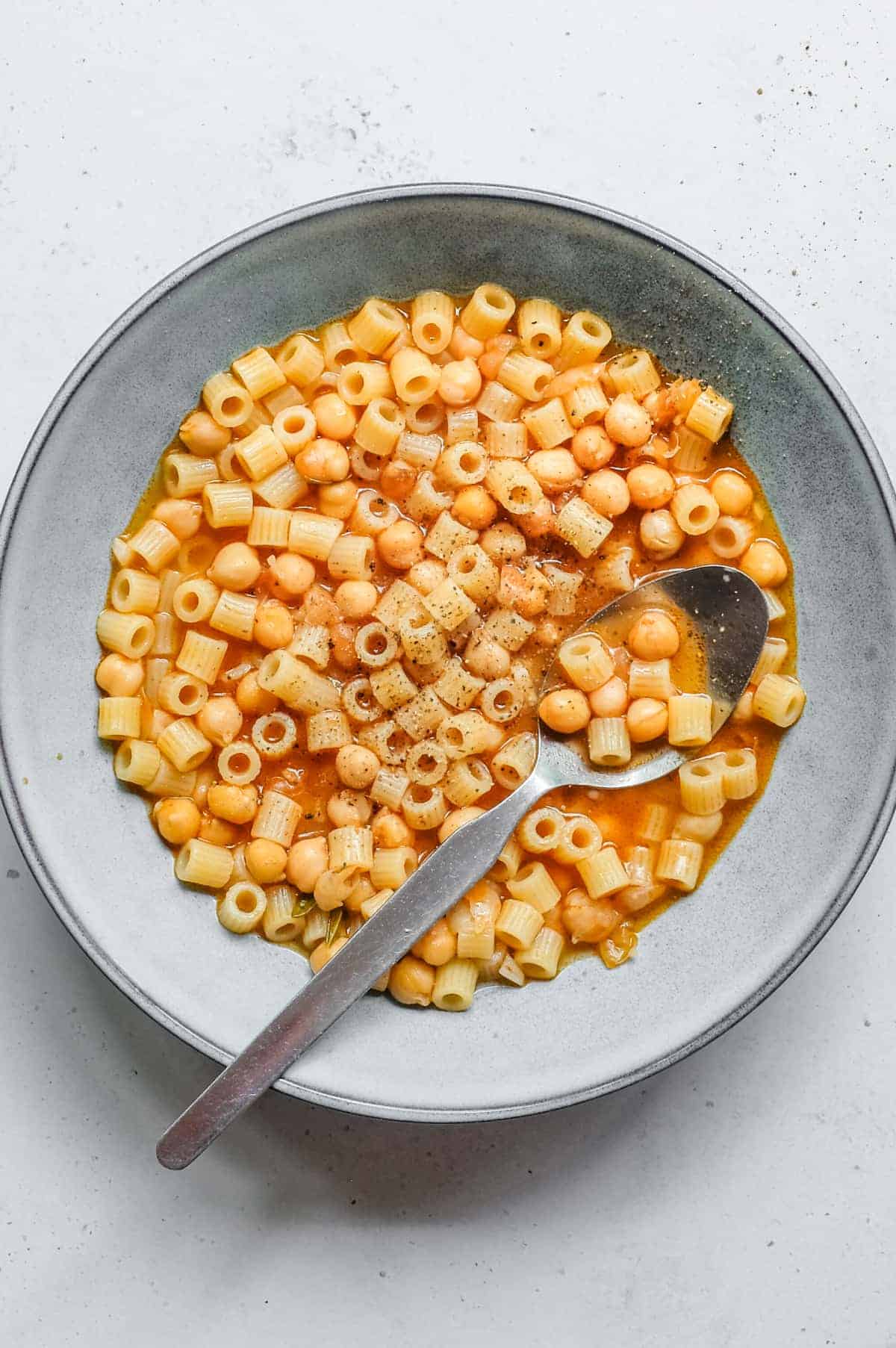 an overhead photograph of a bowl of Italian pasta e ceci (pasta with chickpeas)