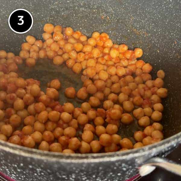 Pasta e Ceci – Italian Pasta with Chickpeas | cookeatworld.com sauteeing the chickpeas in the garlic and tomato paste