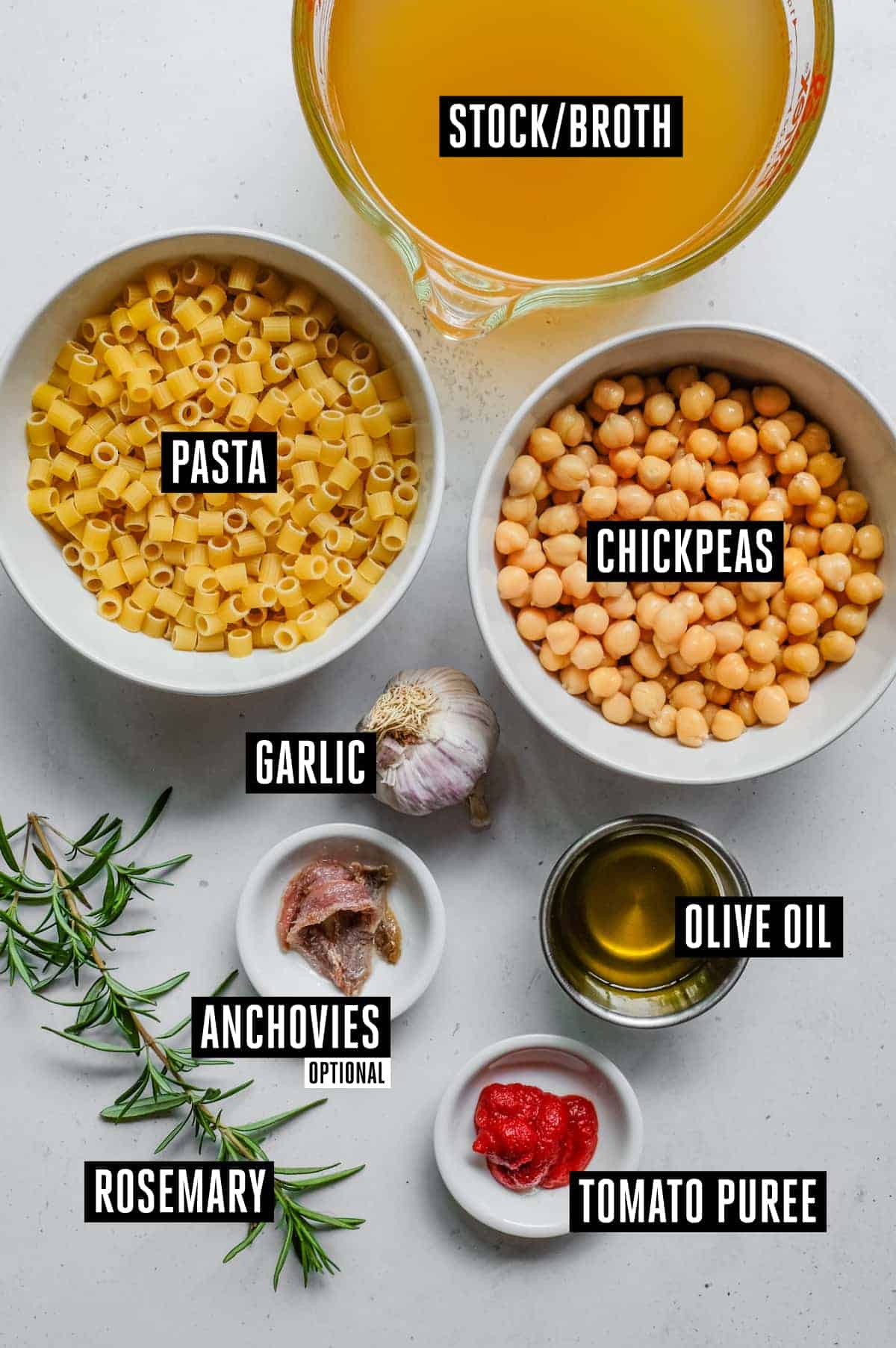 Pasta e Ceci – Italian Pasta with Chickpeas | cookeatworld.com the ingredients for pasta e ceci - stock, chickpeas, ditalini pasta, anchovies (optional), garlic, rosemary, oil, tomato paste.