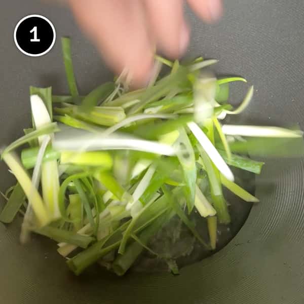 Scallion Oil Noodles (Long You Ban Mian) | cookeatworld.com Spring onions tumbling into a wok with peanut oil.