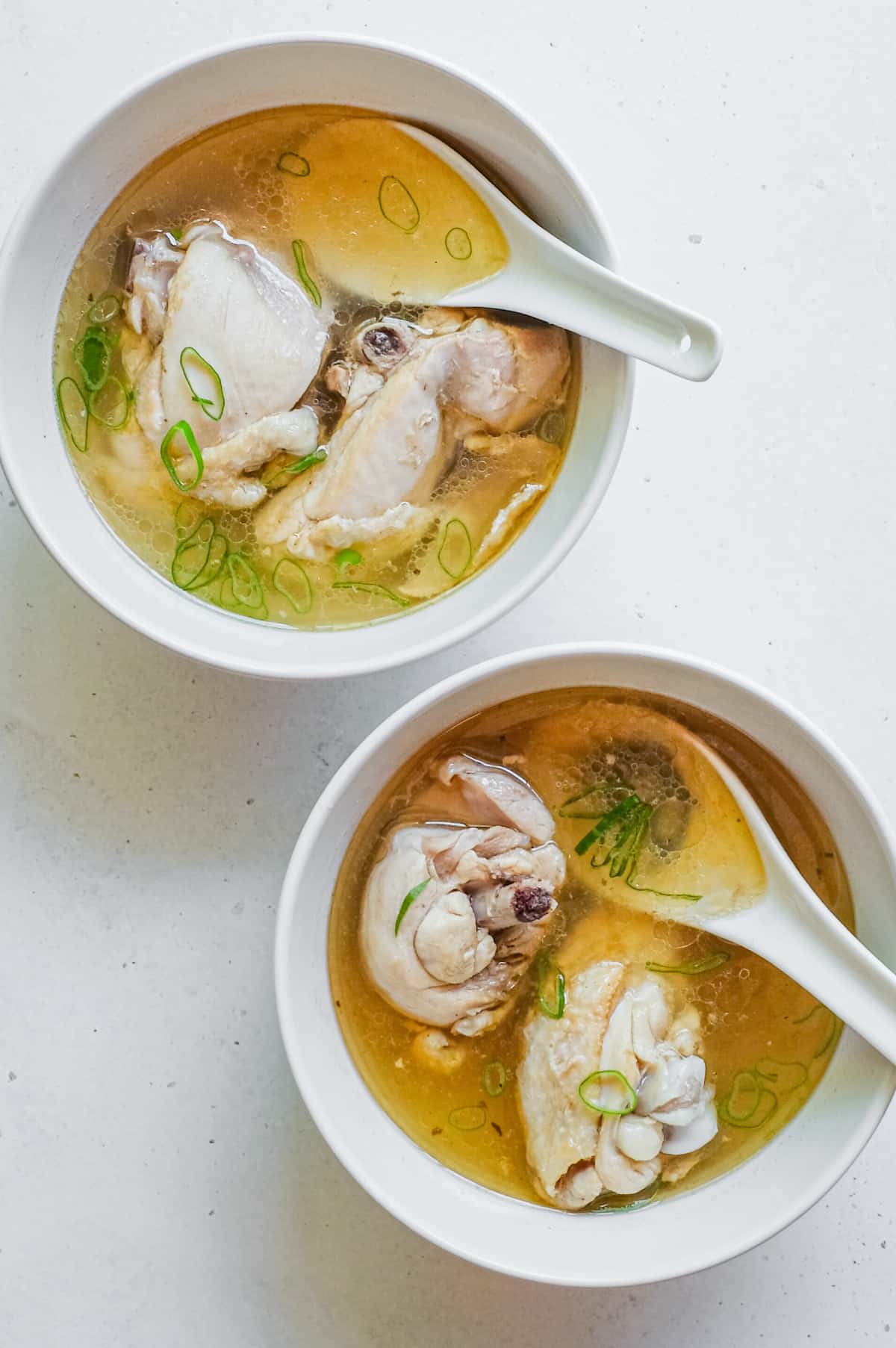 Two small bowls sit side by side with Taiwanese Sesame Oil Chicken Soup