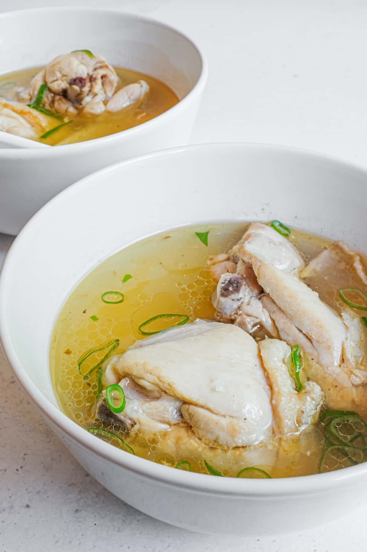 A close up of two bowls of Taiwanese Sesame Oil Chicken Soup