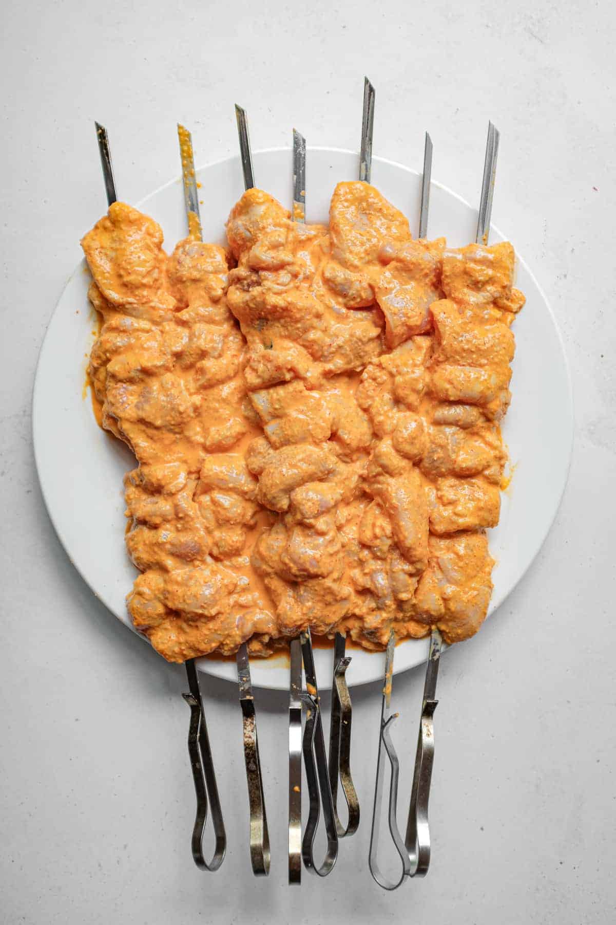Chicken skewers marinating in a Turkish yoghurt sauce