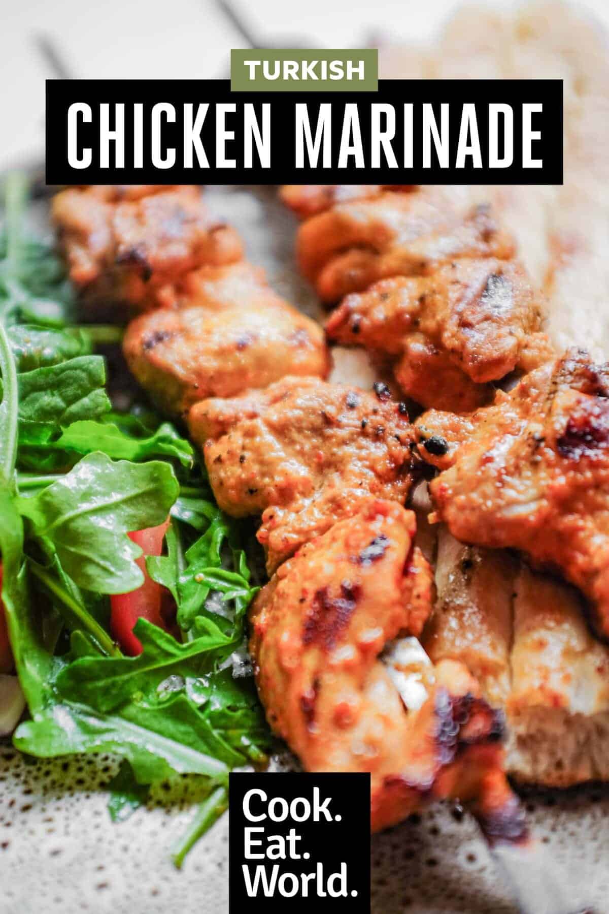 A close shot of chicken kebabs with salad and bread