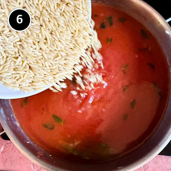 Youvetsi Chicken (Greek Chicken and Orzo Bake) | cookeatworld.com The orzo is poured into the tomato sauce for Youvetsi Chicken.