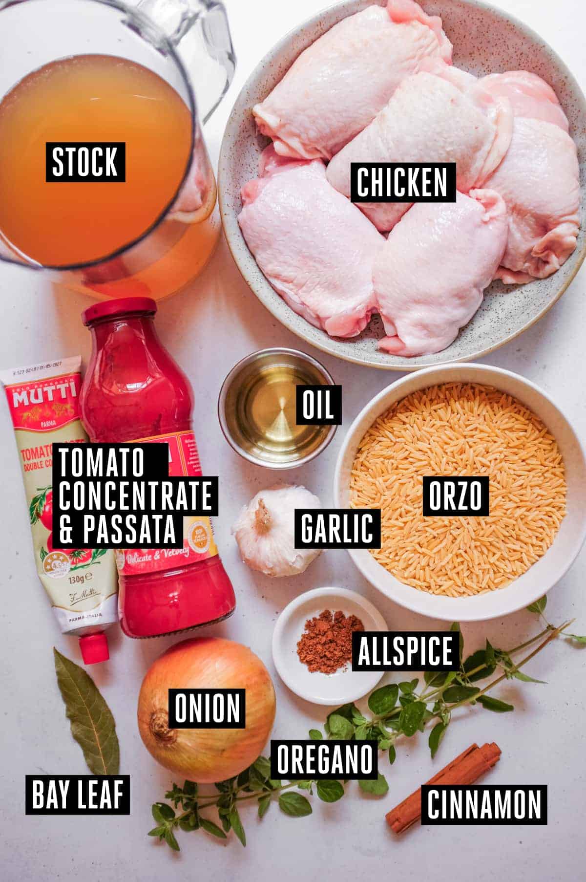 Youvetsi Chicken (Greek Chicken and Orzo Bake) | cookeatworld.com The labelled ingredients for Greek chicken youvetsi including: chicken, stock, tomato puree and concentrate, orzo, garlic, onion, oregano, allspice, bay leaf and cinnamon.