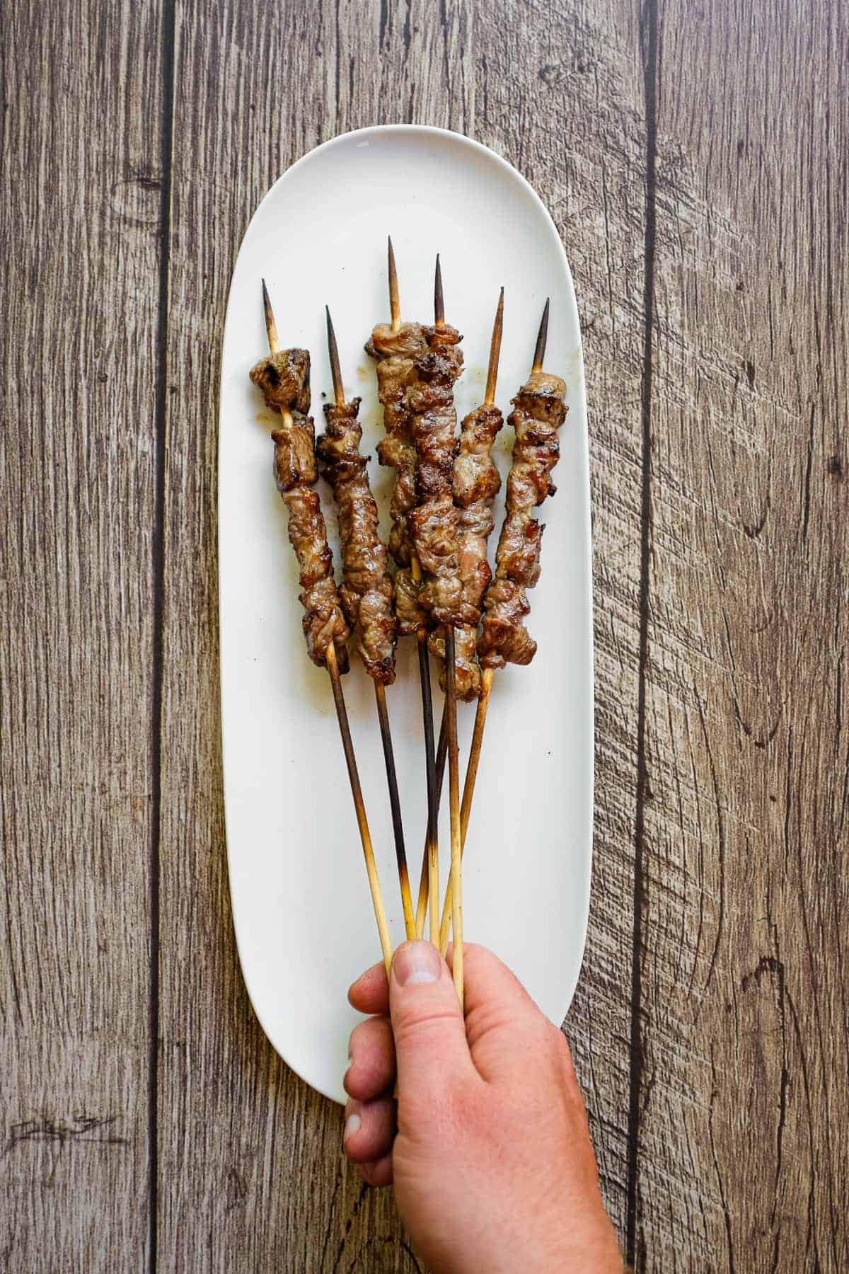 Traditional Abruzzese arrosticini cooked on a narrow grill