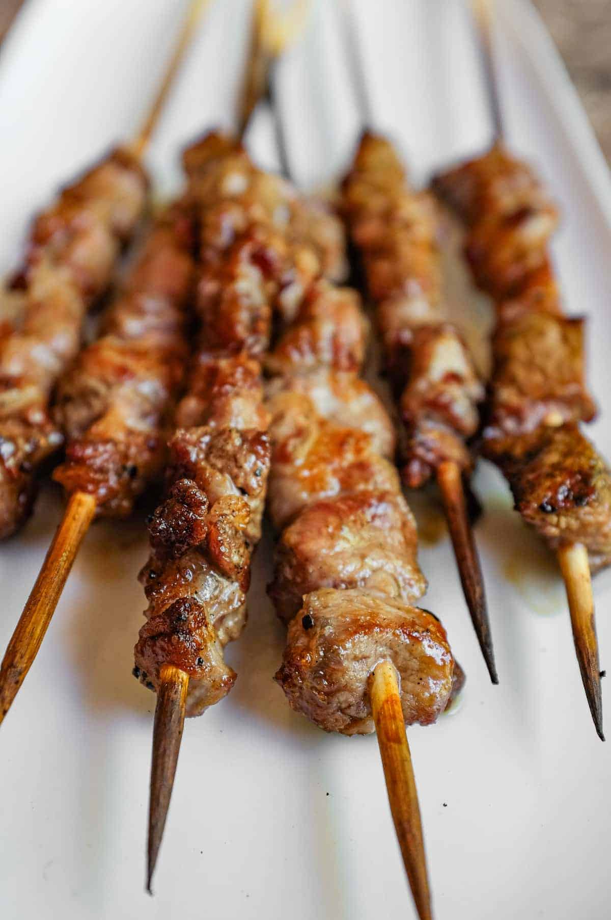Grilled arrosticini lamb skewers charred over hot coals