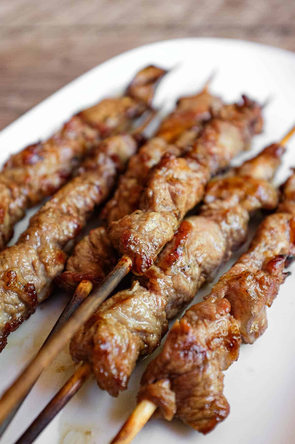Rustic grilled arrosticini lamb skewers served hot