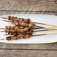 Finished arrosticini skewers resting after grilling